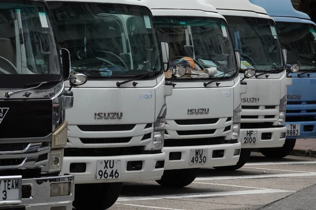 Row of light commercial trucks lined up for delivery