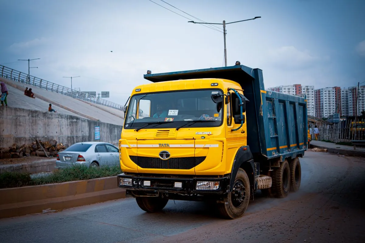 Yellow Tata tipper truck on an urban road